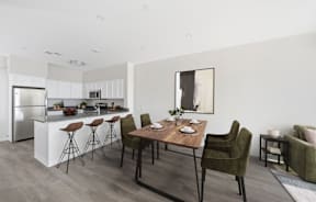 A modern kitchen with a dining table and chairs.