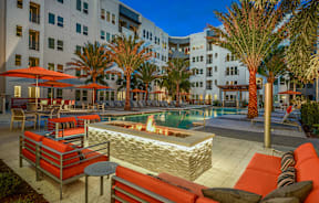 A poolside area with a fire pit and seating area.