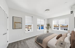 A bedroom with a large bed and a view of the city.