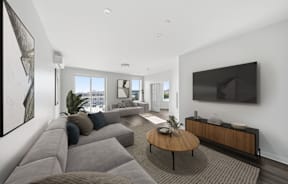 A modern living room with a grey sofa and a wooden coffee table.
