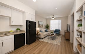 A modern kitchen with black appliances and white cabinets.