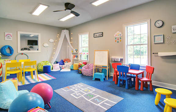 a childrens play room with a variety of toys and a table and chairs