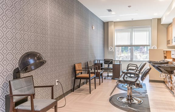 a barbershop with chairs and a hair dryer