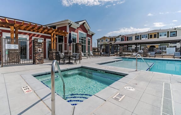 our apartments have a swimming pool and a patio with chairs