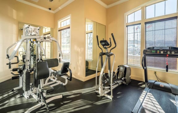 a gym with exercise equipment and windows at Highland Hills, Dallas, TX, 75241
