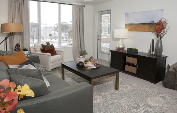 Bright Living Room With Large Window at The Legends of Columbia Heights 55+ Living, Columbia Heights, MN, 55421