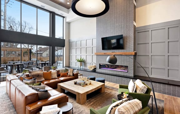 a large living room with a fireplace and a televisionat Millberry Apartments, St. Paul Minnesota