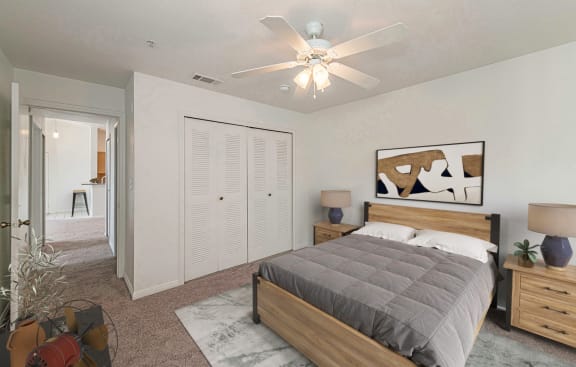 a bedroom with a bed and a ceiling fan at Pinewood Apartments, Texas