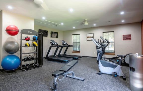 the gym is equipped with cardio equipment and weightsat Stoneridge Apartments, Pflugerville Texas