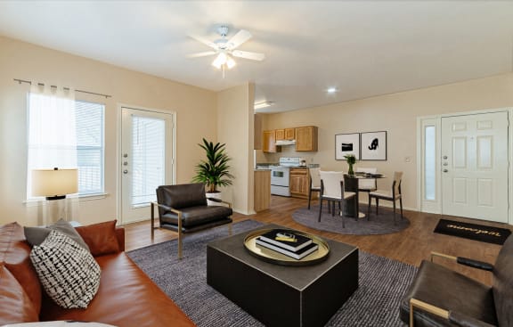 a living room with a couch and a coffee table in front of a dining roomat The Springs, Pasadena Texas