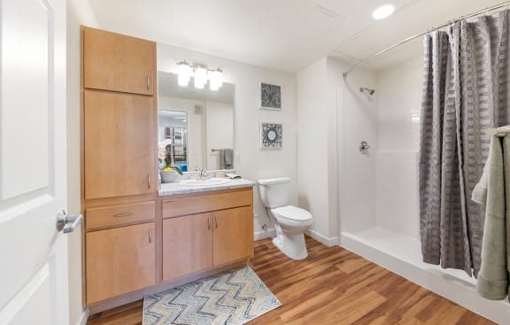 a bathroom with a toilet and a shower and a sink at Ventura at Tradewinds, Midland, TX, 79706
