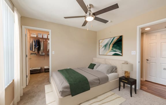 a bedroom with a bed and a ceiling fan at Vermillion Apartments, Houston, TX