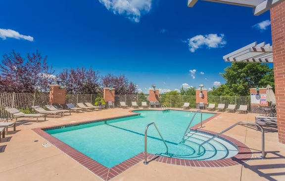 our apartments have a resort style pool with chaise lounge chairs at The Bluffs at Nine Mile Creek, Eden Prairie, 55344