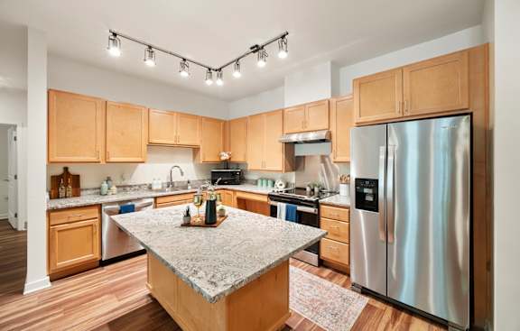 A kitchen with wooden cabinets and a granite countertop. at Creekridge on the Park Apartments, Charlotte, NC, 28212