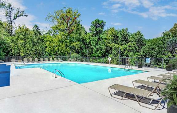 a swimming pool with apartment buildings in the background at The Flats on Waters Edge, Tennessee, 37076
