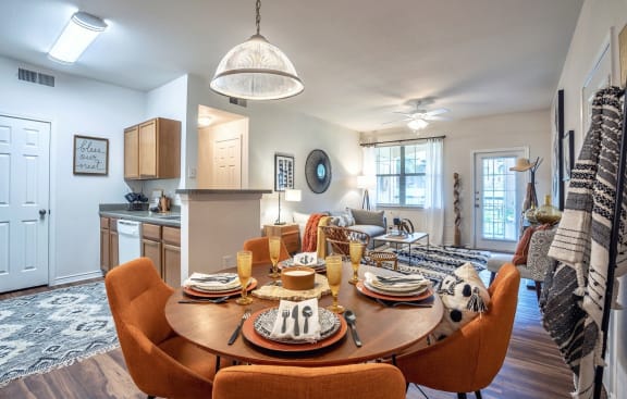 a dining room and living room with a table and chairsat Stoneridge Apartments, Pflugerville