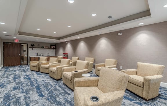 a lobby with a couch and chairs and a fire place  at Willow Place 55+ Apartments, McDonough, 30253
