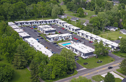 an aerial view of a group with a swimming pool and trees