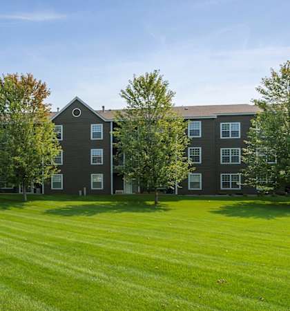 a large green lawn in front of an apartment building  at Mallard Ridge, Maple Grove, MN