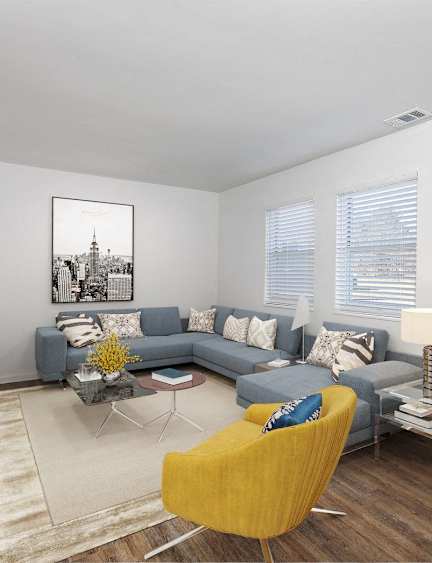 a living room with a gray couch and a yellow chair