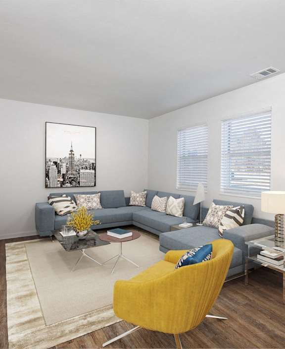 a living room with a gray couch and a yellow chair