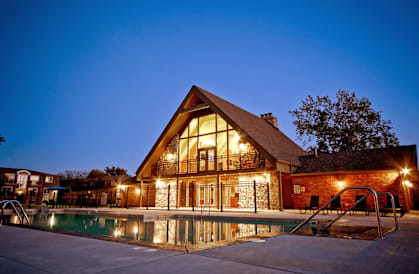 a house with a swimming pool at night