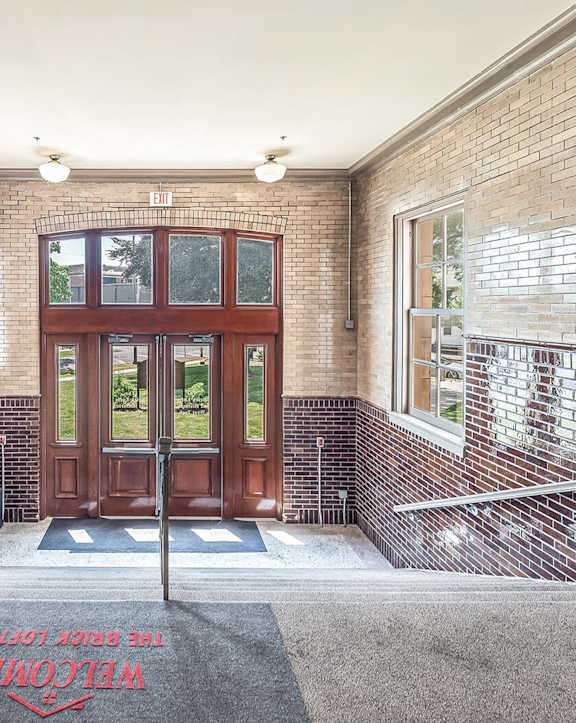A brick building with a red carpet in front of it.