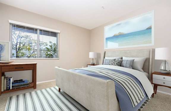 a bedroom with a bed and a window