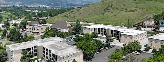 A large building with a pool in the middle of a parking lot.