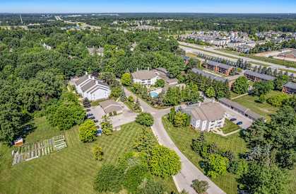 A bird's eye view of a residential area with houses and greenery.