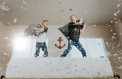 Two people are throwing papers into the air.