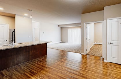 A room with wooden floors and white walls.