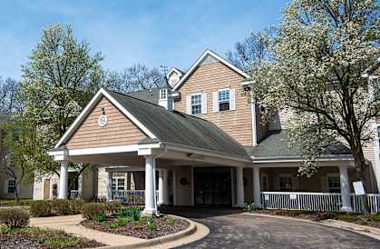 A house with a brown roof and a white porch.