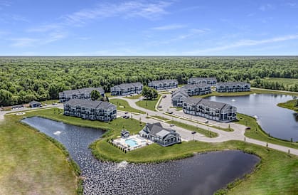 A bird's eye view of a resort with a large lake and buildings.