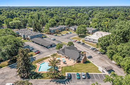 A bird's eye view of a residential complex with a swimming pool.
