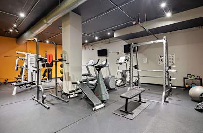 a gym with weights and cardio equipment in an apartment building