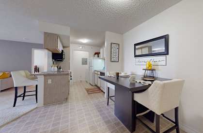 a kitchen and dining room with a table and chairs