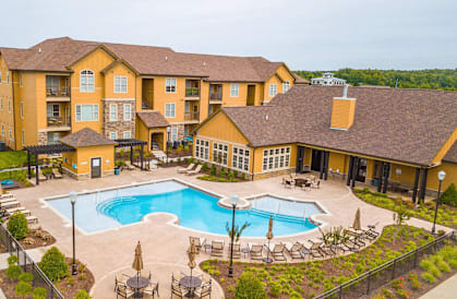 A large building with a pool in front.