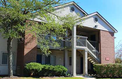 the front of an apartment building with a balcony and stairs  at Eagle Crest Apartments, Galloway
