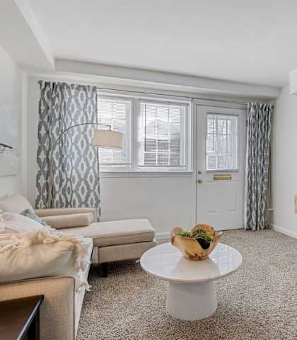 Living room with sectional couch Cross at Country Manor Apartments, Baltimore, MD