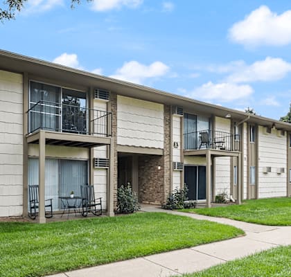 an exterior view of a building with a lawn and a sidewalk