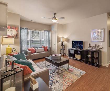 A living room with a couch, chairs, and a coffee table.