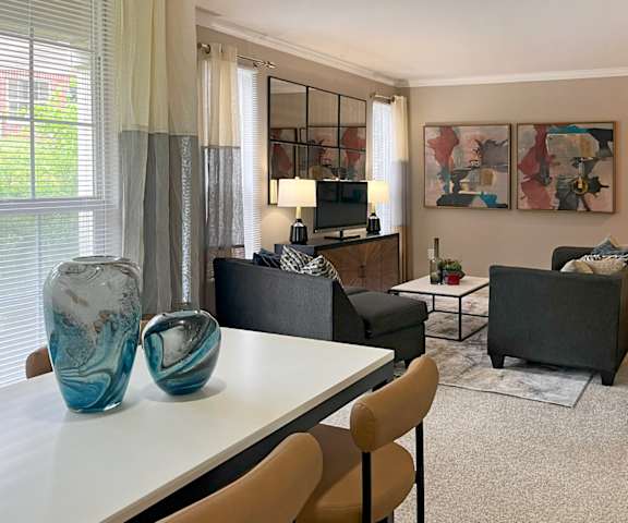 A living room with a white table and two chairs.