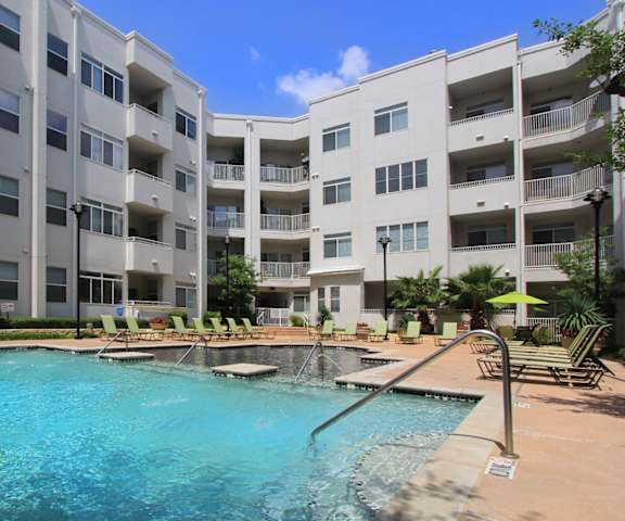 A swimming pool in front of apartment buildings.