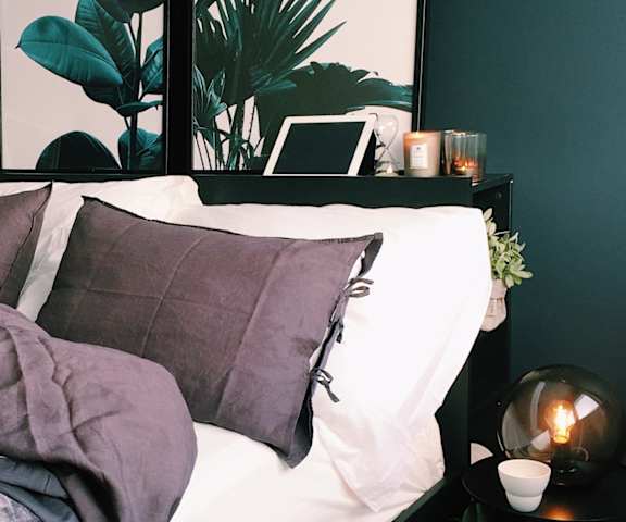 bedroom with model furniture and plush bedding