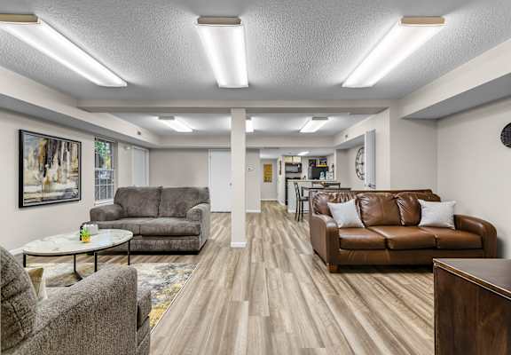 apartment living room with couches and chairs
