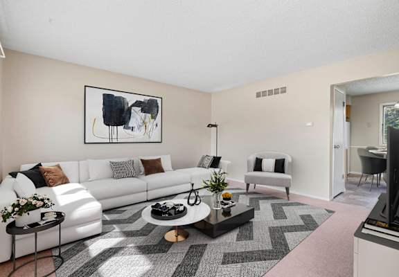 a living room with a white couch and a black coffee table