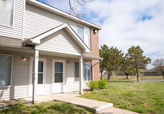 A house with a white front door and a small porch.