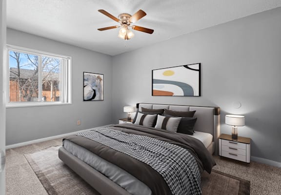 a bedroom with a large bed and a ceiling fan
