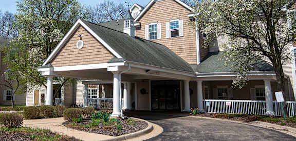 A house with a brown roof and a white porch.